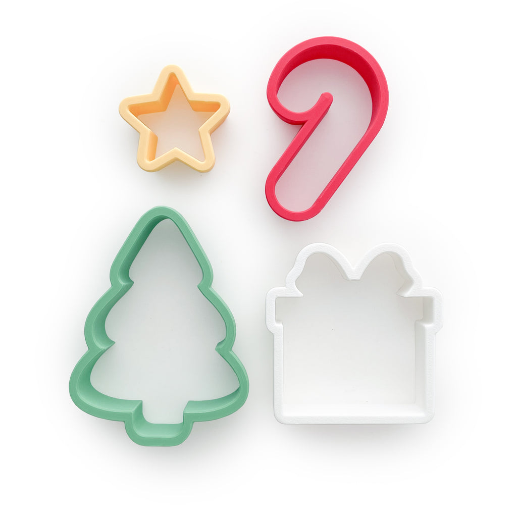 Christmas dough cutters, yellow star, red candy cane, green pine tree, white present