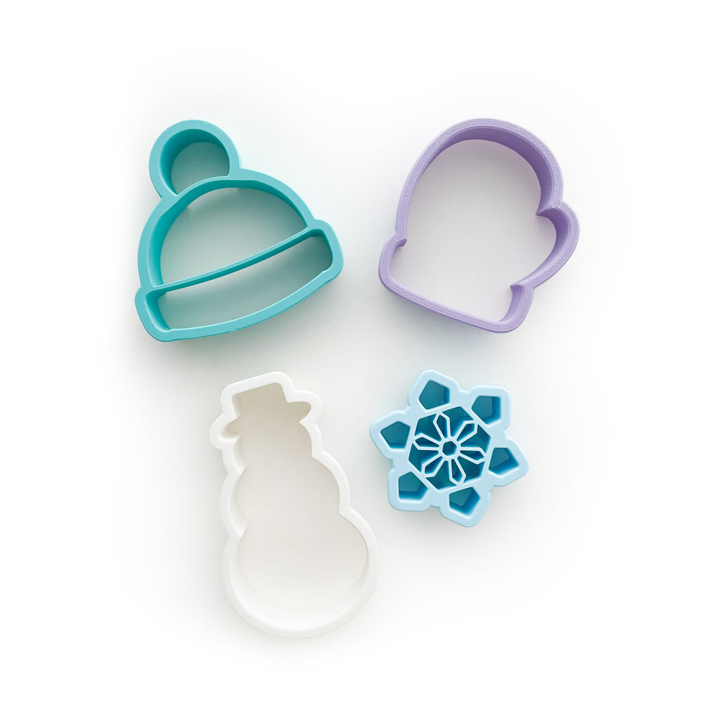 Frosty dough cutters, teal hat, purple mitten, white snowman, and blue snowflake