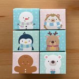 Winter Parlour Pals®, Snowman, Hedgehog, Penguin, Reindeer, Gingerbread Man, and Polar Bear, in cute little favor boxes for gifting tubs of dough shown on wooden table