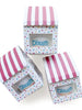 Birthday favor boxes with red and white striped awnings and colourful polkadot packaging with a window showing the dough tub inside