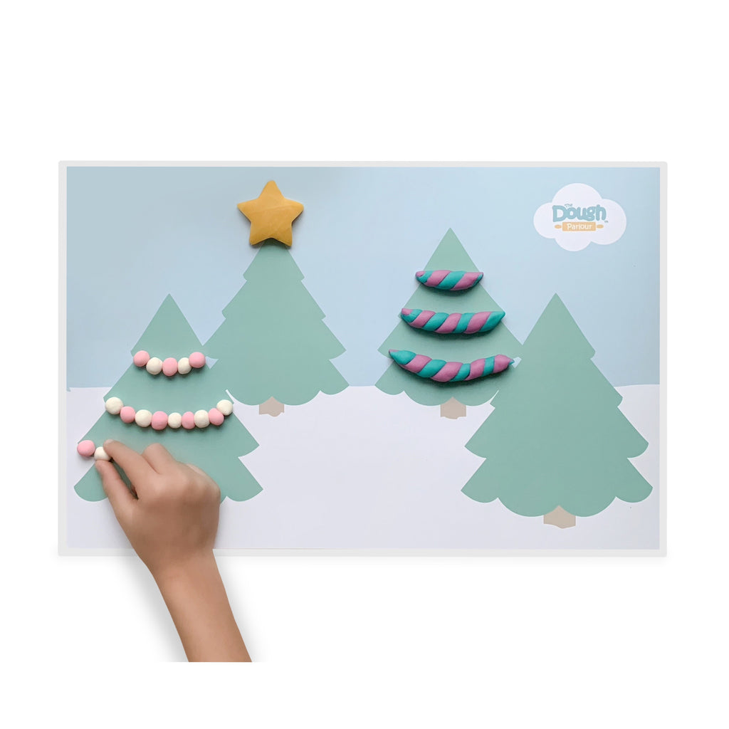 Holiday Playmat showing 4 pine trees decorated with dough by a child