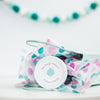 Tub of Cotton Candy scented dough in a gift bag with colourful tissue and blue bunting in the background