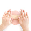 child's hands rolling out Bubble Gum scented pink dough with wooden rolling pin