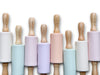 Eight silicone rollers with wooden handles in various colours lined up vertically